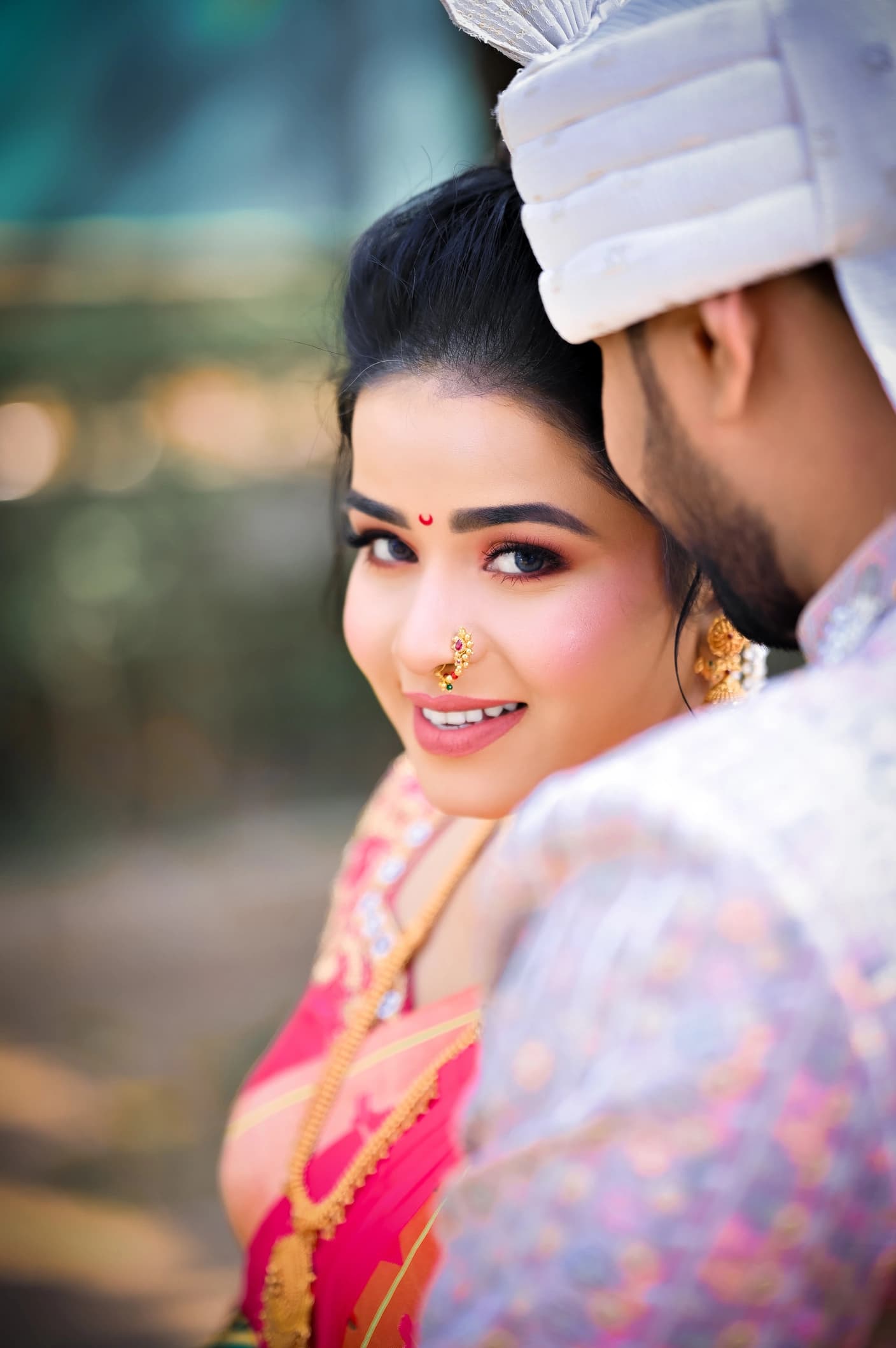Smiling bride looking over the groom's shoulder, candid wedding close-up